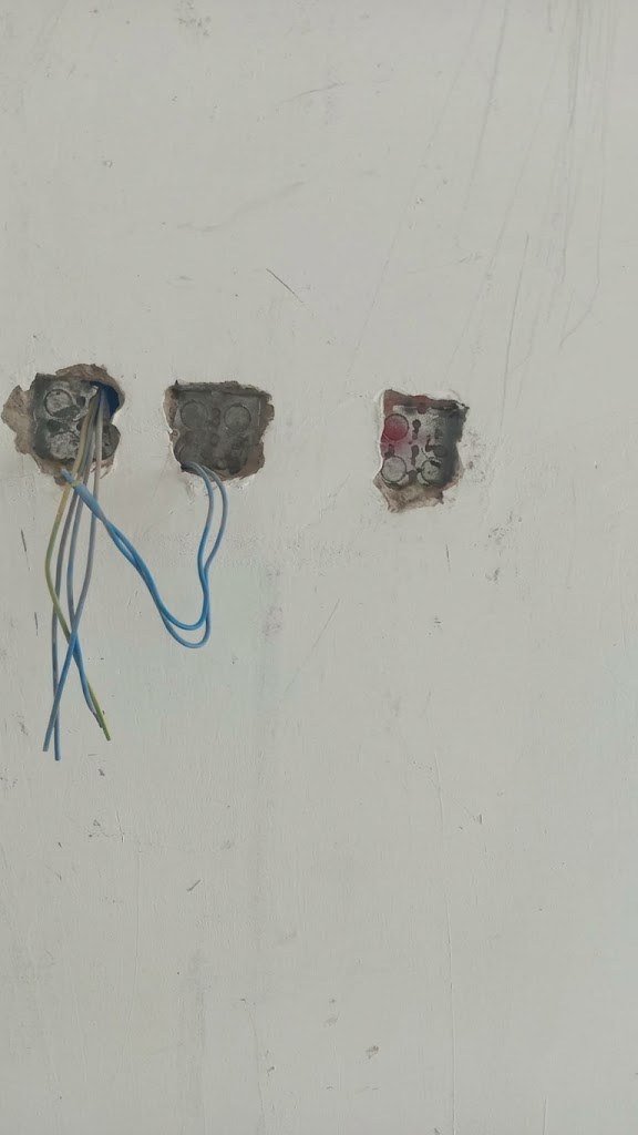 Three socket back boxes with cables in an unfinished wall