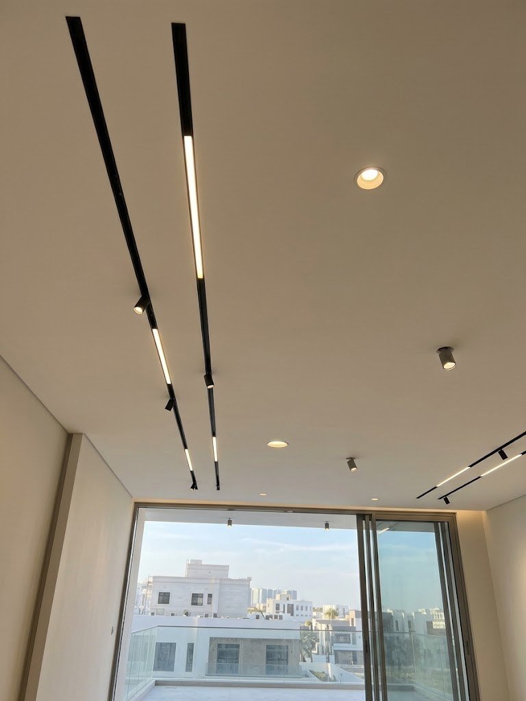 Linear track lights and downlights in a villa room, villa lighting design Dubai