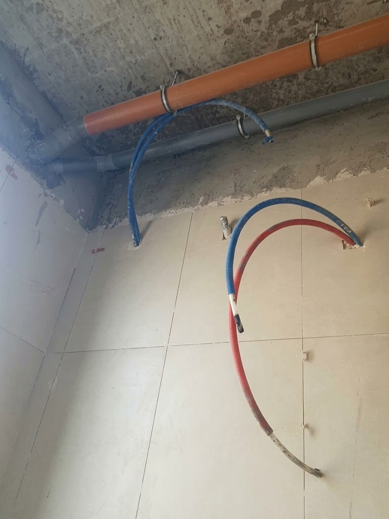 Hot and cold water pipes and drainage pipework before wall finishes